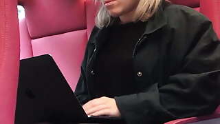 blond beauty with legs crossed in nylons working on train